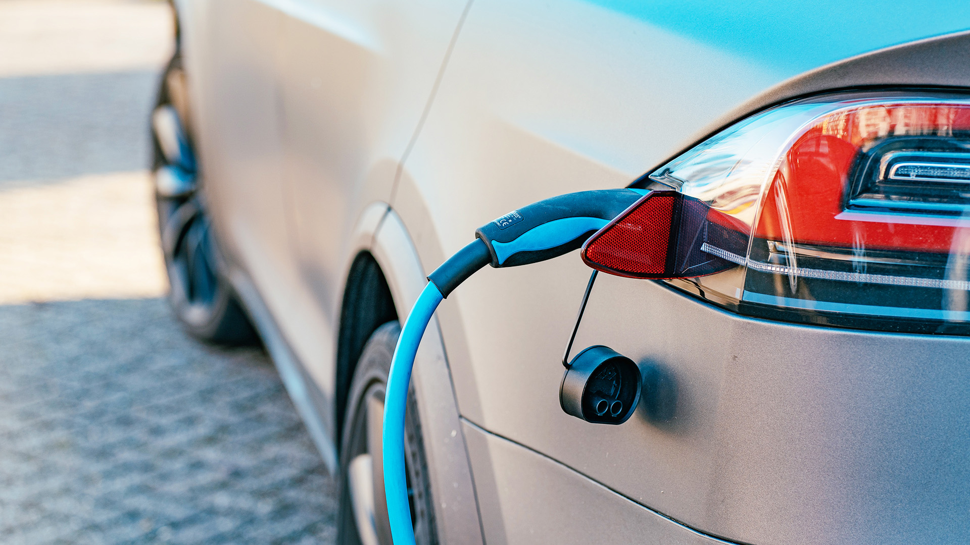 Photograph showing an electric car being charged.